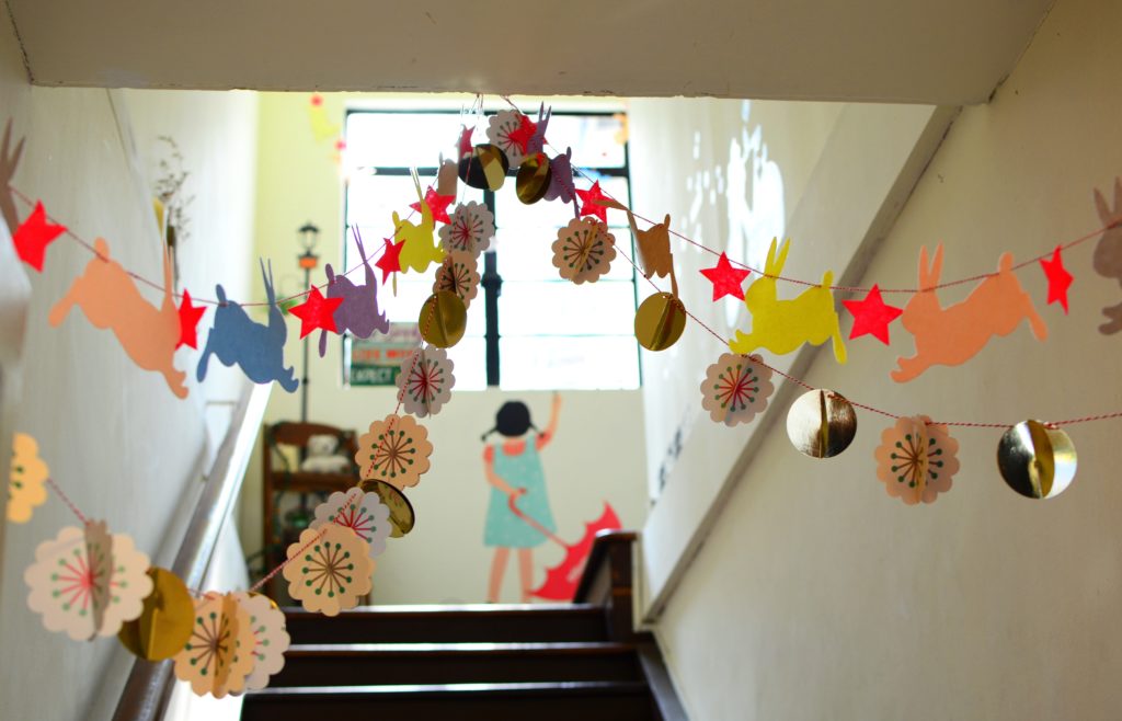 A colourful school corridor with hanging bunting.